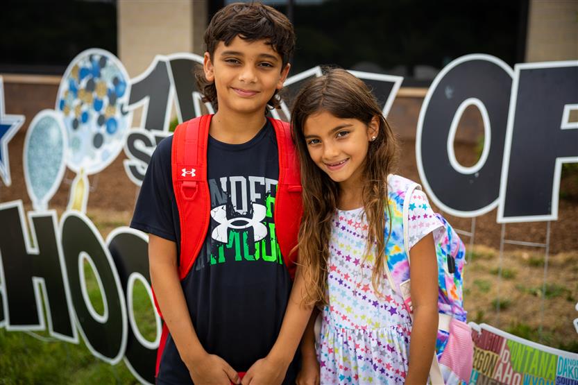 Two students smile